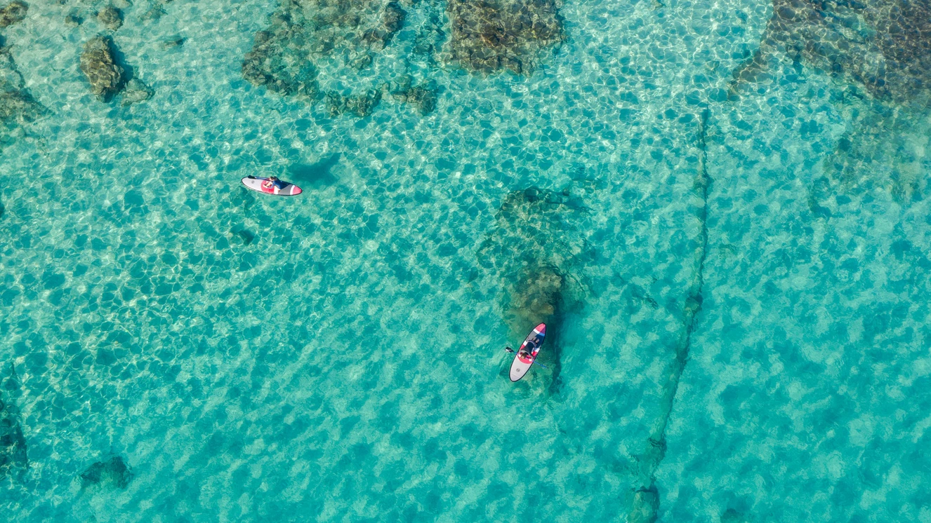 Stand up paddleboarding in clear water near Fuerteventura