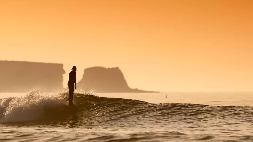 Surfer riding an Algarve wave in Portugal